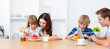 Happy family eating breakfast in the kitchen