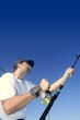 Angler fisherman trolling rod and reel fishing