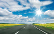 Country road and blue cloudy sky