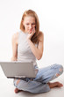 red-haired girl with laptop on white