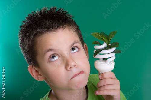 Photo: Kid with energy saving bulb Kid with energy saving bulb