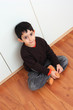 Photo: smiling child sitting in small bedroom smiling child sitting in small bedroom