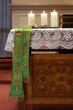 Three burning candles on church altar