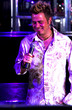 Young adult at a nightclub singing karaoke