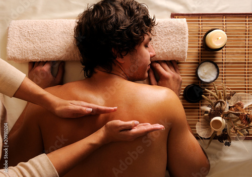 Photo: young guy in a beauty salon getting massage young guy in a beauty salon getting massage