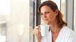 Cute mature woman drinking a cup of coffee