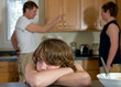 boy nearly cries as father yells at his brother