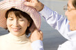 妻の帽子を直している夫