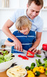Jolly father and his son cooking
