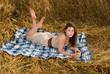 Beautiful slavonic girl on picnic in wheat field with apple