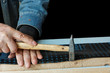 construction worker nails insulation film on plank (isolated) construction worker nails insulation film on plank (isolated)