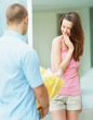 Young man giving a flower bouquet to his girlfriend