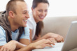 Closeup of a happy young couple surfing on internet