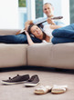 Photo: Footwear on floor - Couple listening music together in backgroun Footwear on floor - Couple listening music together in backgroun