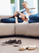 Photo: Footwear on floor - Love couple enjoying music in background Footwear on floor - Love couple enjoying music in background
