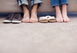 Foto: Young couple sitting together with feet beside footware Young couple sitting together with feet beside footware