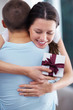 Foto: Hug - Happy young girl with a gift from her boyfriend Hug - Happy young girl with a gift from her boyfriend