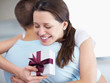 Cute young woman embracing her boyfriend on her birthday