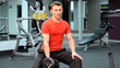 Man training in gym lift dumbbells