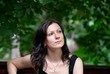 Young sad woman siiting outdoors