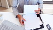 Business woman examining graphs at her desk
