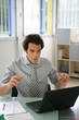 Homme en costume de devant ordinateur portable