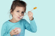 little successful girl eating yogurt