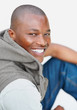 Closeup of a handsome happy man sitting on white