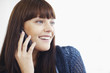 Foto: Happy woman using cell phone and looking at her side Happy woman using cell phone and looking at her side