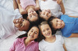 Top view of little children lying together in a circle