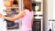 Mature female looking for food in refrigerator