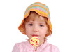 little girl with colorful hat and lollipop