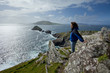 man on cliffs looking out on islands