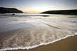 wave speeding into sandy beach at twilight,dingle,ireland