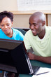 Photo: two adult students studying computer together two adult students studying computer together