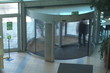 People spinning in and out revolving door