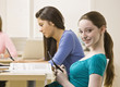 Students text messaging on cell phones