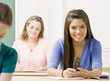 Student text messaging on cell phone in classroom