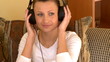 Pensive woman listening music sitting on sofa at home Pensive woman listening music sitting on sofa at home