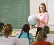 Teacher explaining globe to students