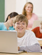 Student using laptop in classroom