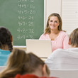 Teacher with laptop in classroom