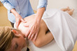 Massage therapist giving woman massage