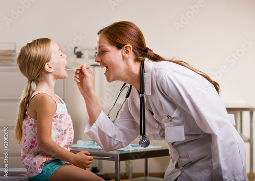 Photo: Doctor giving girl checkup in doctor office Doctor giving girl checkup in doctor office