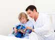 Cute little boy playing guitar with his father Cute little boy playing guitar with his father