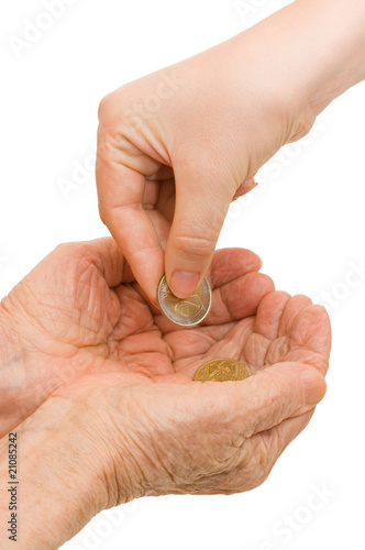Photo: Young and old hand with a coin Young and old hand with a coin