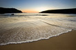 wave speeding into sandy beach at twilight,dingle,ireland