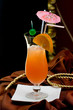 Fresh iced cocktail garnished orange and umbrella.