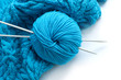 blue clew with 2 needls is on blue knitted linen