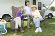 Mother, daughter and grand daughter sit outside RV home